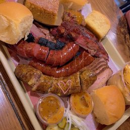 Redbird BBQ signature dishes Cajun Cheddar Sausage, Chopped Beef, Beef Koobideh Sausage.
